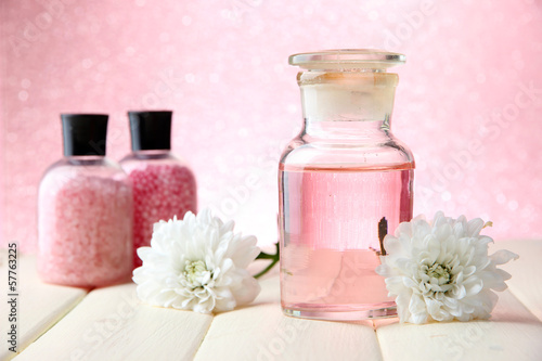Glass bottle with color essence, on pink background