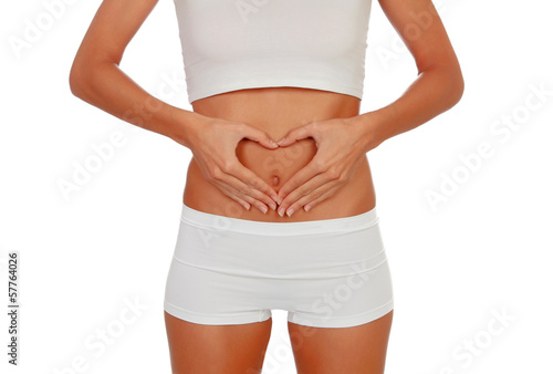 Girl in white underwear forming a heart with her hands on her be