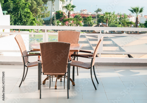 Table with four chairs standing on open air terrace © Kekyalyaynen