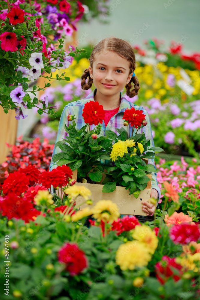 Flowers garden, girl holding flowers in garden center