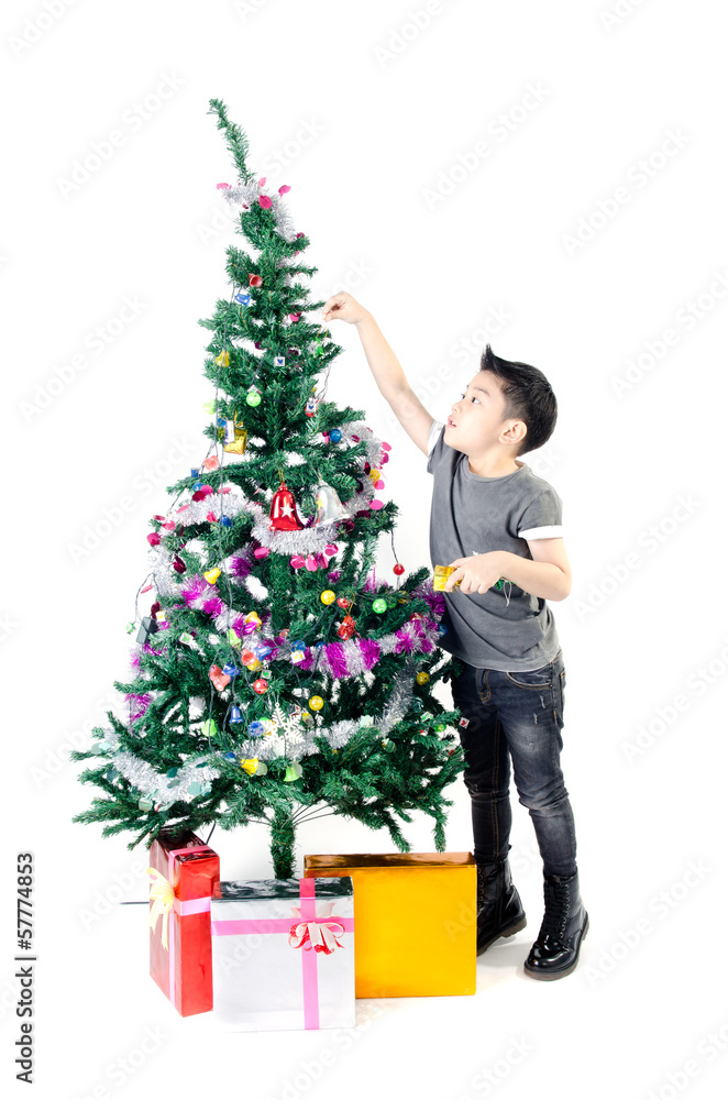 Asian cute boy with gift box ,decorate Christmas tree . Asian cute boy with gift box ,decorate Christmas tree .