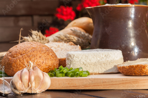 Country breakfast consisting of bread, cheese, milk and garlic.