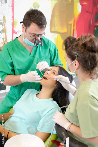 Dentist curing a female patient