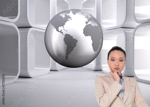 Composite image of thoughtful asian businesswoman pointing