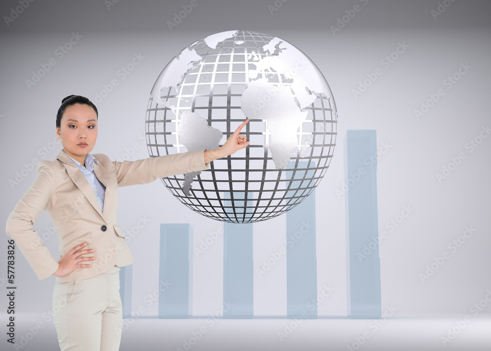 Composite image of unsmiling asian businesswoman pointing Composite image of unsmiling asian businesswoman pointing