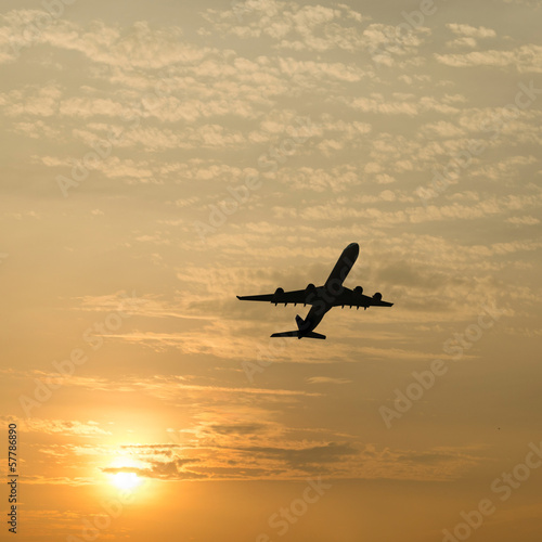 Silhouette of an airplane with sunset sky