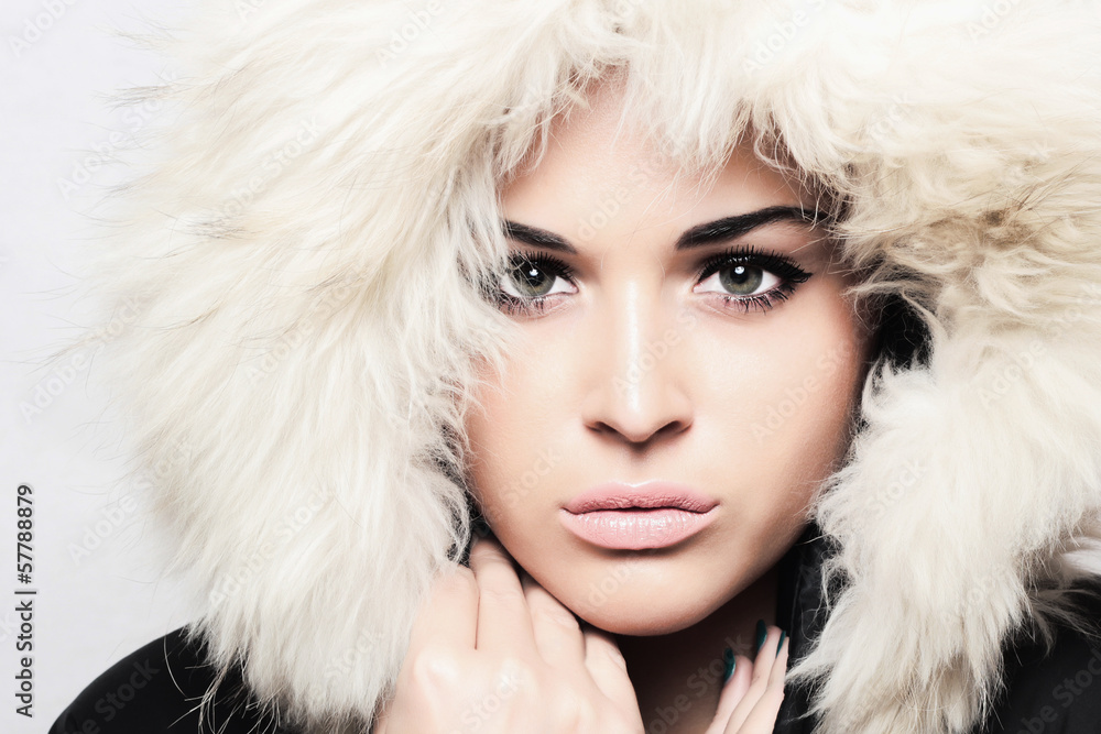 young beautiful woman with fur. white fur hood. winter style