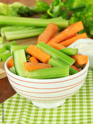 Fresh green celery with vegetables in bowl on table close-up