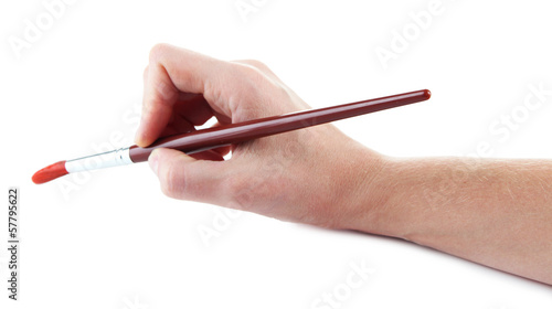 Hand holding brush with red paint isolated on white