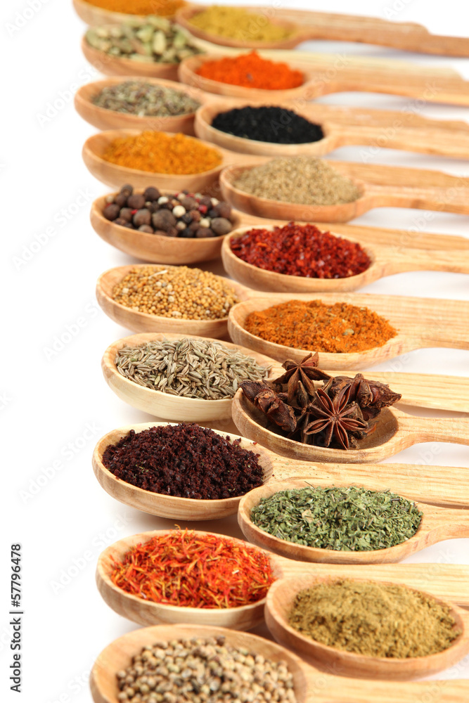 Assortment of spices in wooden spoons, isolated on white Assortment of spices in wooden spoons, isolated on white