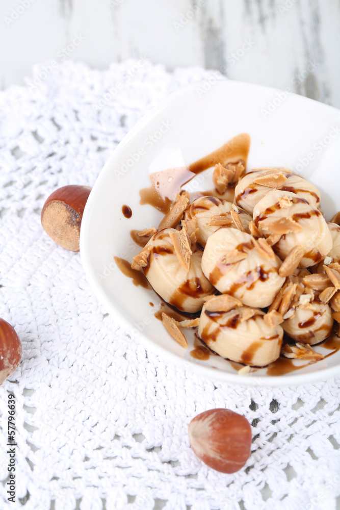 Many toffee in bowl on napkin close-up Many toffee in bowl on napkin close-up