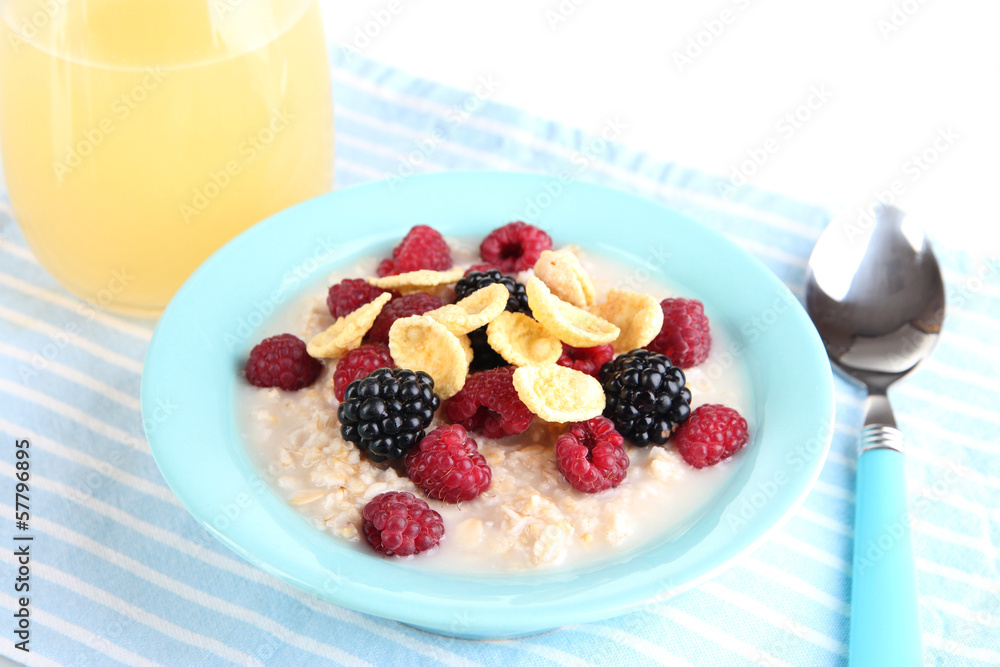 Oatmeal in bowl with berries isolated on white Oatmeal in bowl with berries isolated on white