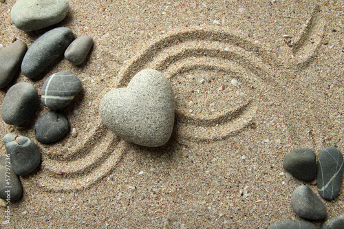 Canvas Print Grey zen stone in shape of heart, on sand background