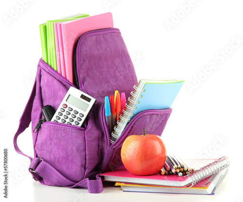 Purple backpack with school supplies isolated on white photo