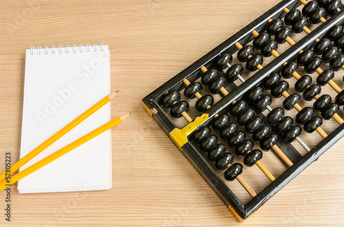 Ancient Chinese abacus,notebook,pencil photo