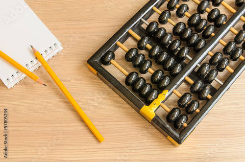 Ancient Chinese abacus,notebook,pencil photo