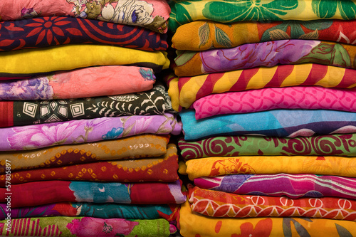 Heap of cloth fabrics at a local market in India. Close up .