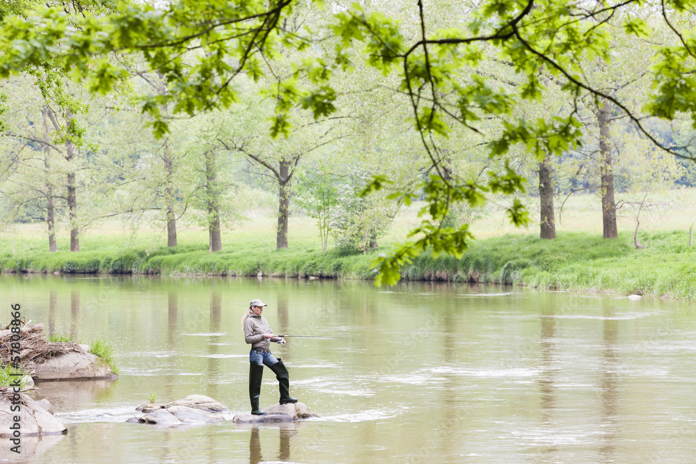woman fishing in Sazava river, Czech Republic woman fishing in Sazava river, Czech Republic