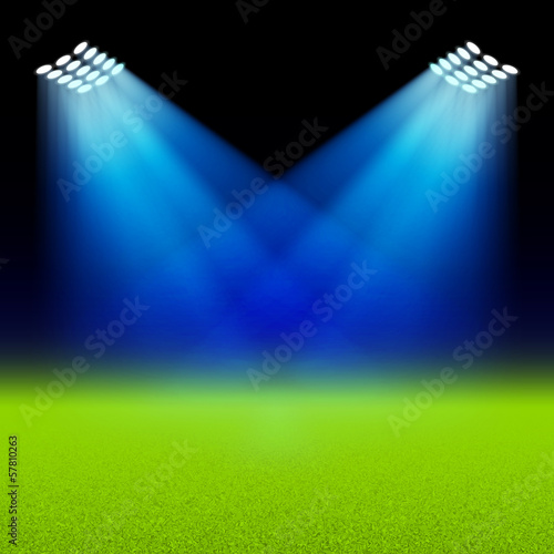 Bright spotlights illuminated green field stadium