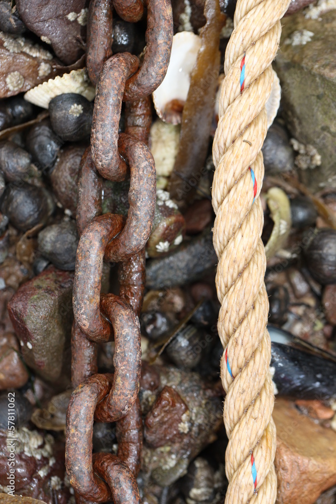 Rusty Chain and Rope on Pebble Beach Rusty Chain and Rope on Pebble Beach