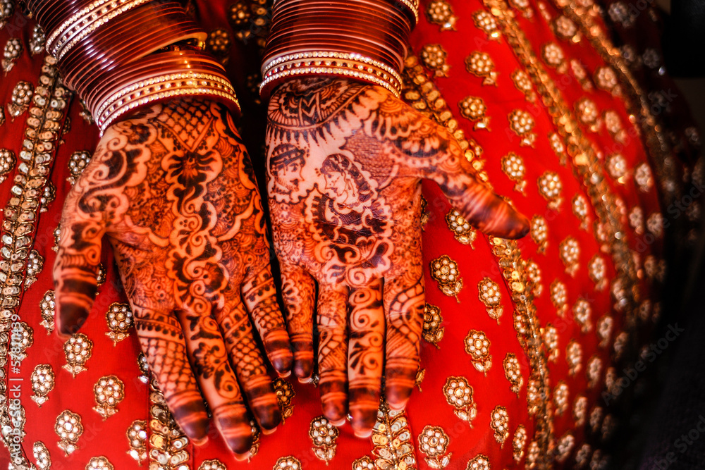 Beautiful Henna and bangles on bride's hands.