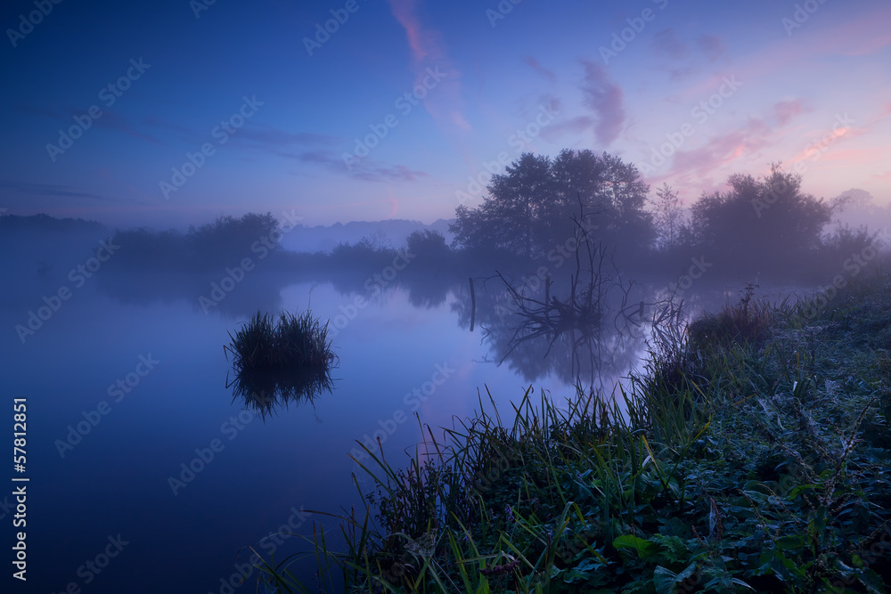 Fototapeta premium misty sunrise over lake