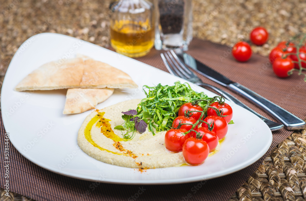 Plate with hummus dip and tapas