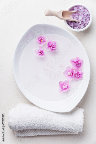 Flowers in white bowl with sea ​​salt for SPA