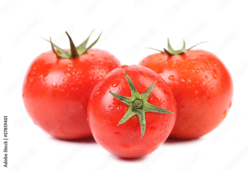Three fresh tomatoes with drops.