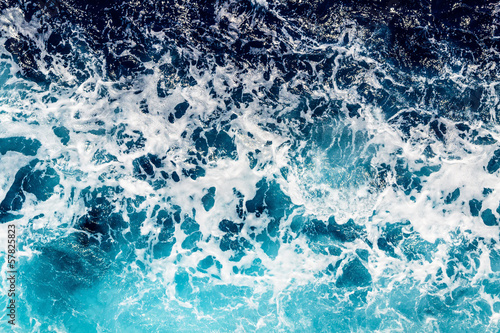 Deep blue sea water with spray