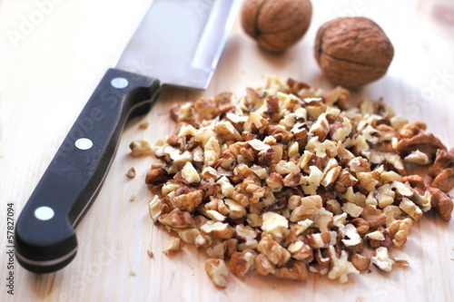 Chopped walnuts on wooden background