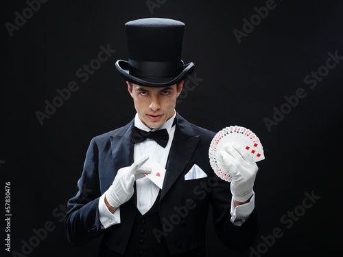 magician showing trick with playing cards photo