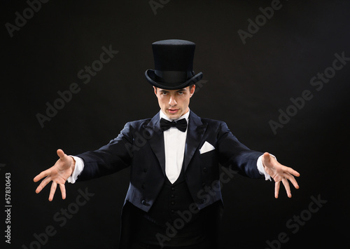 magician in top hat showing trick