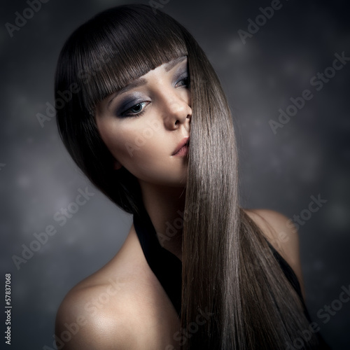Portrait of a beautiful brunette woman with long straight hair