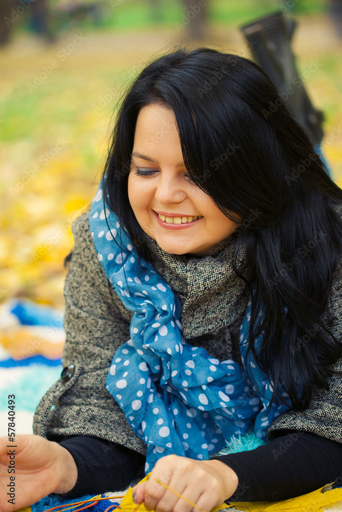 Young woman laying in autumn leaves Young woman laying in autumn leaves