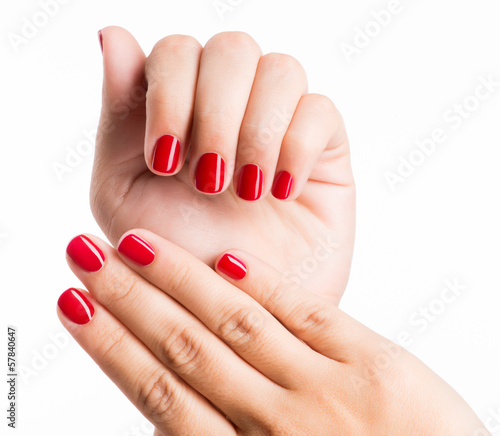 Closeup photo of a female hands with red nails