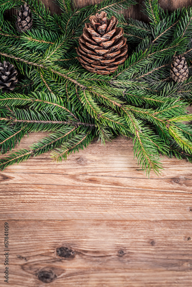 Naklejka premium christmas tree branches with bumps on wooden background
