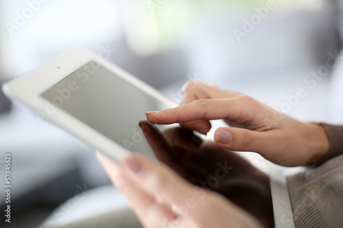 Closeup of hand sliding on digital tablet