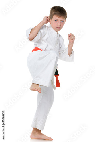Young boy in kimono in fighting stance