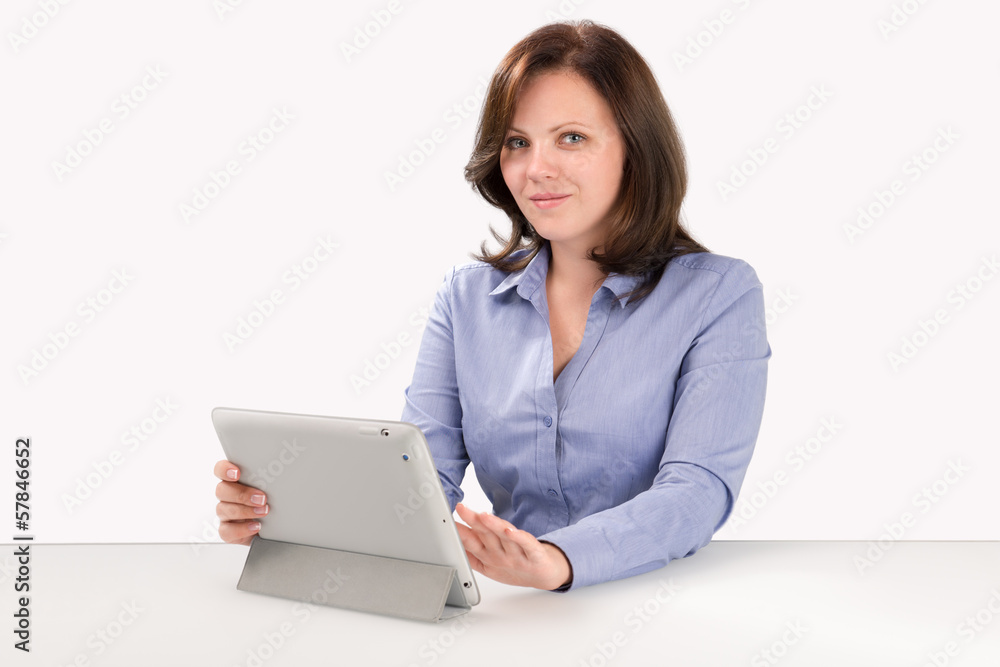 Young woman is sitting at the table with tablet computer Young woman is sitting at the table with tablet computer