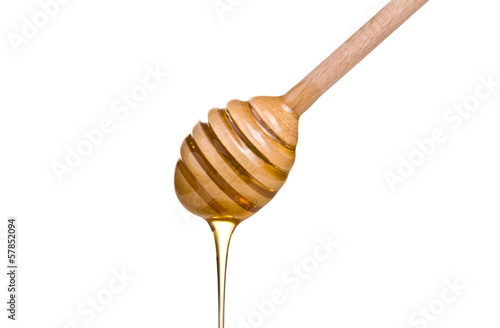honey is dripping from the spoon
