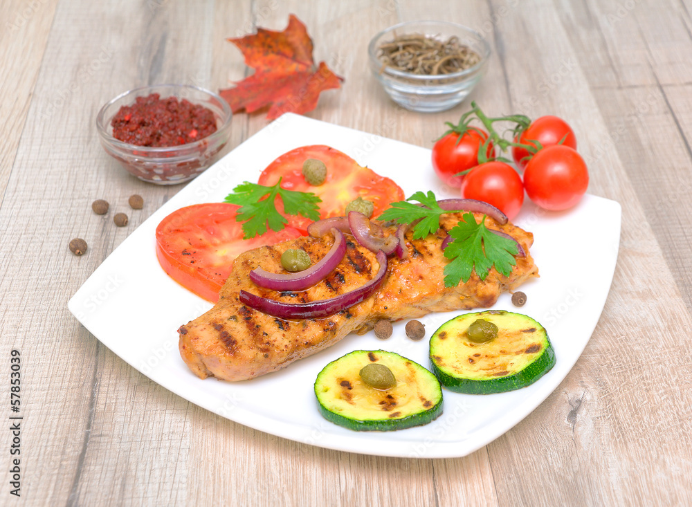 Grilled meat with vegetables on a wooden table Grilled meat with vegetables on a wooden table