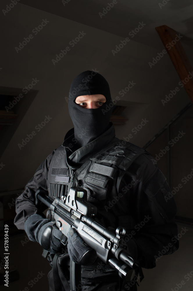Special forces soldier is aiming and shooting on the target Special forces soldier is aiming and shooting on the target