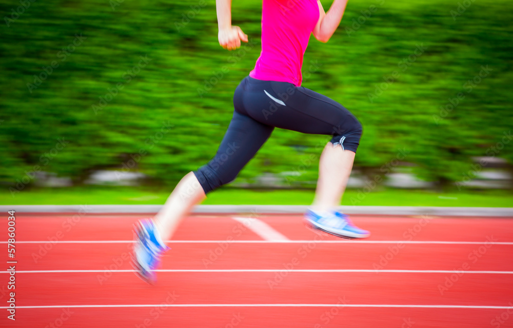Tableau sur toile Motion blurred runners body (color toned image)