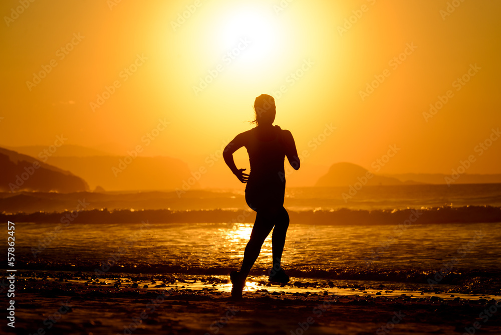 Woman running on beautiful sunset