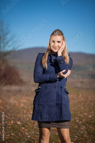 Beautiful blond young woman wearing coat outdoors © ekaterina1922