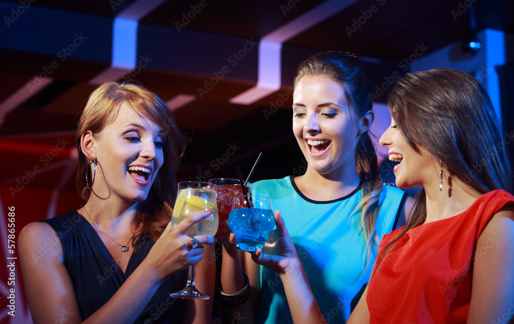 Young female friends celebrating in a nightclub