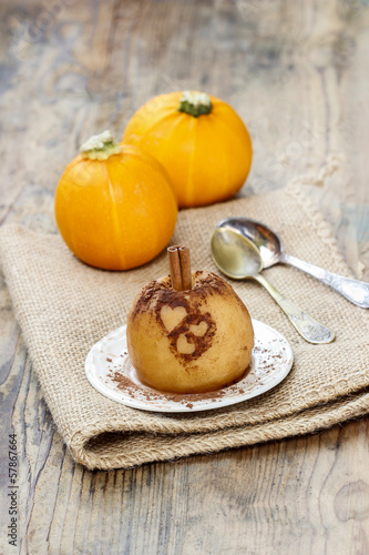 Baked apple decorated with cinnamon heart shape ornament