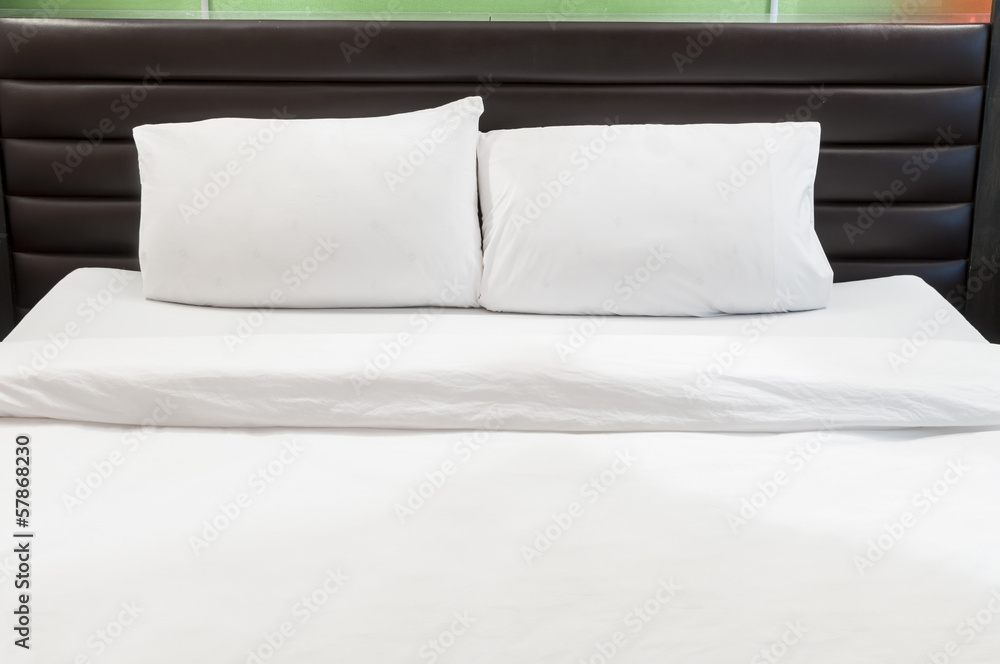 two white pillows on a bed two white pillows on a bed