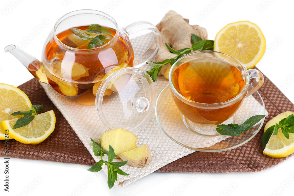 Kettle and cup of tea with ginger on napkin isolated on white Kettle and cup of tea with ginger on napkin isolated on white